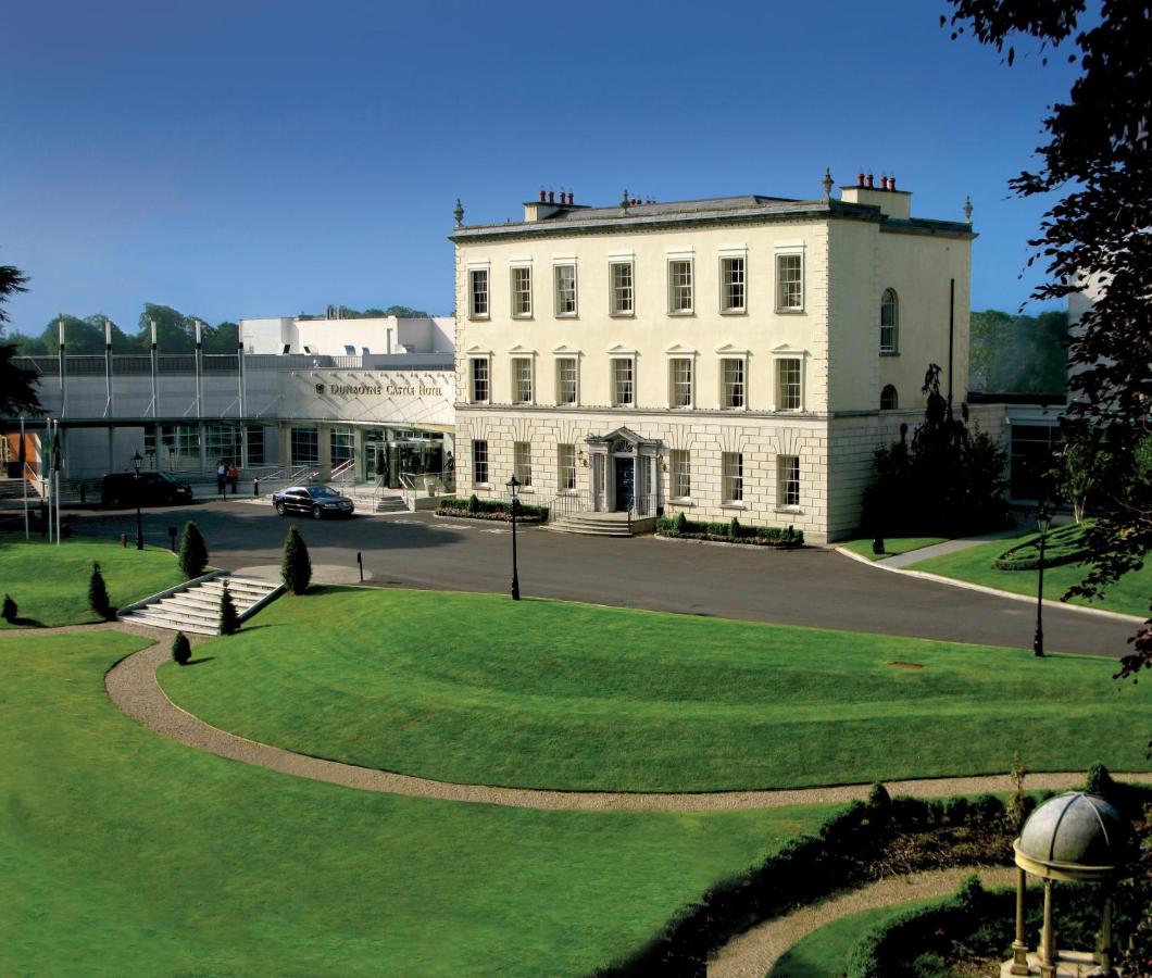 Elegant hotel with manicured lawns and a grand entrance to the main building.