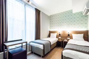 Cama o camas de una habitación en Melrose Hotel